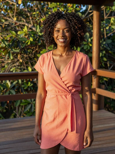 Destiny, 28, Afro-Guyanese single from Linden with natural curly hair on wooden veranda - verified dating profile
