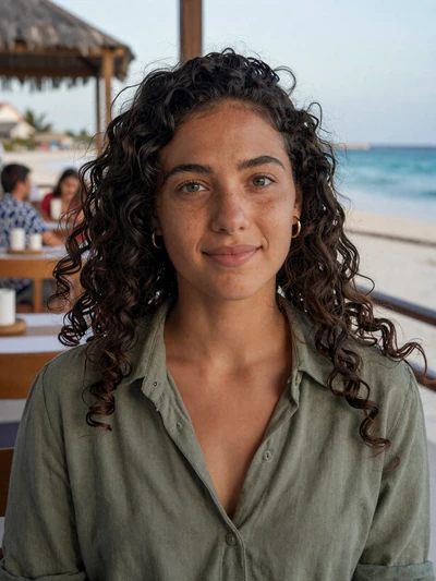 Danaë, 26, Sint Maarten woman with green eyes and curly hair at Philipsburg beachside restaurant - verified profile