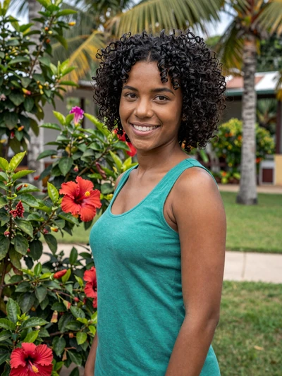 Claudia, 25, Cuban single from Holguín with natural curls in tropical garden with hibiscus flowers - verified dating profile
