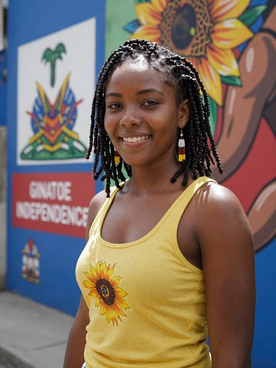 Gaëlle, 27, Haitian single from Gonaïves with locs beside Haitian independence mural - verified dating profile
