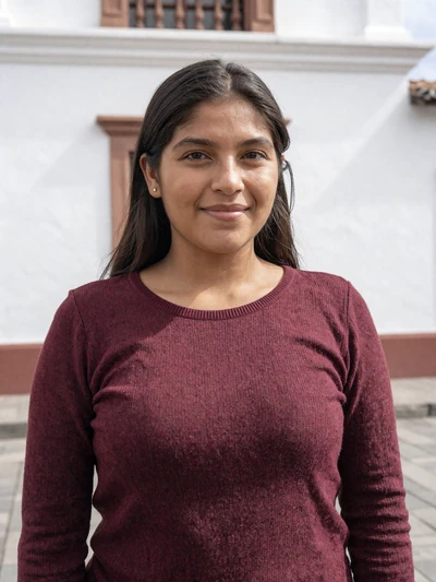 Paola, 27, Bolivian single from Sucre in burgundy top at white colonial building - verified dating profile